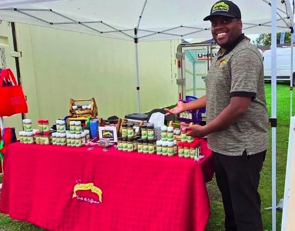 A Trueheart's Blend maker beside a market table filled with spice jars at the Alaska State Fair