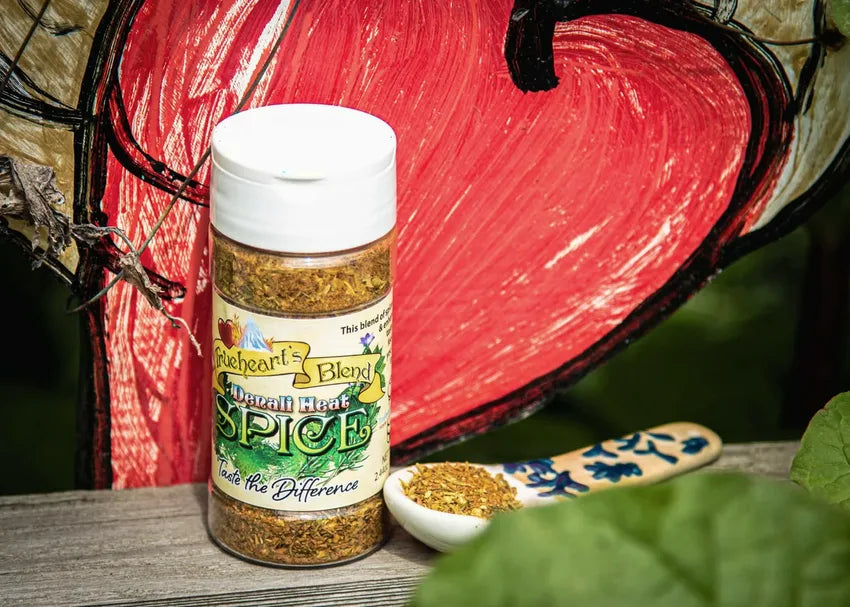 Denali Heat seasoning jar and spoon in front of a hand-painted red heart
