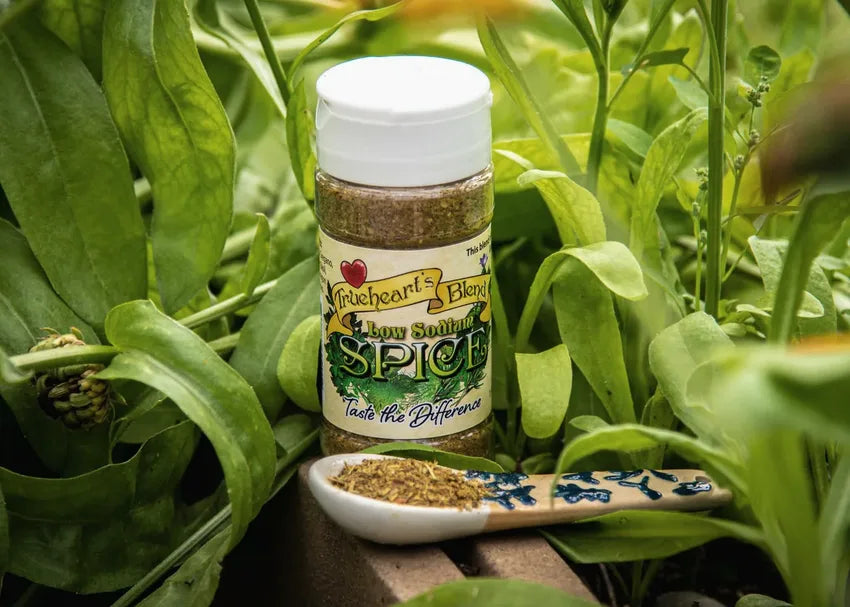 Low Sodium Original seasoning jar nestled among fresh green leaves with a spoonful of the blend