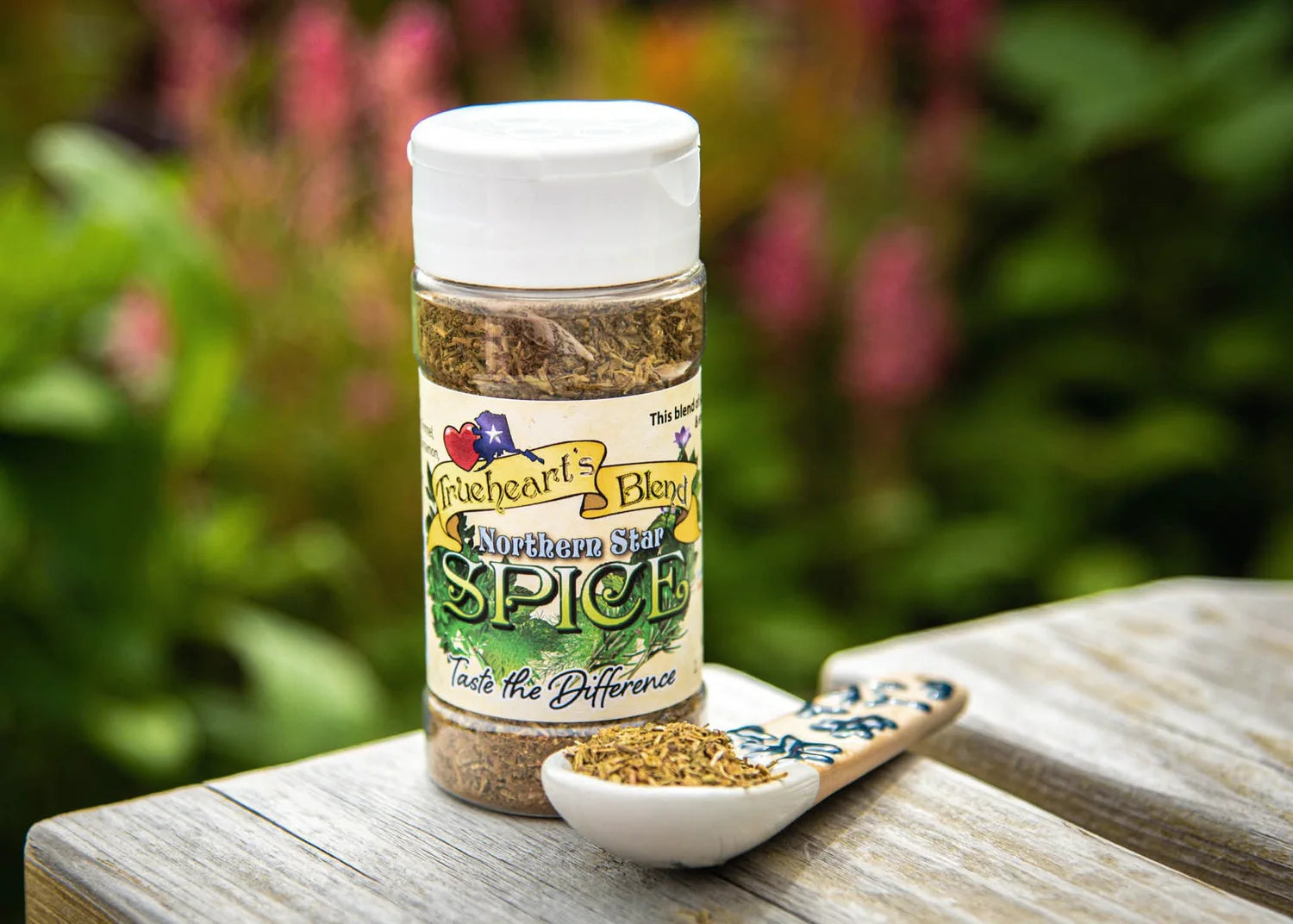 Northern Star seasoning jar and spoon on weathered wood in a garden